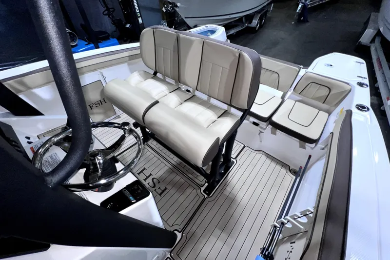 Slide: The Image of 2023 Yamaha Boats 255 FSH Sport E interior with seating and steering wheel. - 26