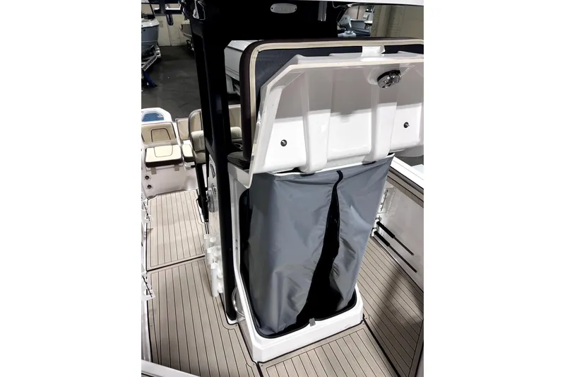 Slide: The Image of 2023 Yamaha Boats 255 FSH Sport E interior with storage compartment and seating. - 27