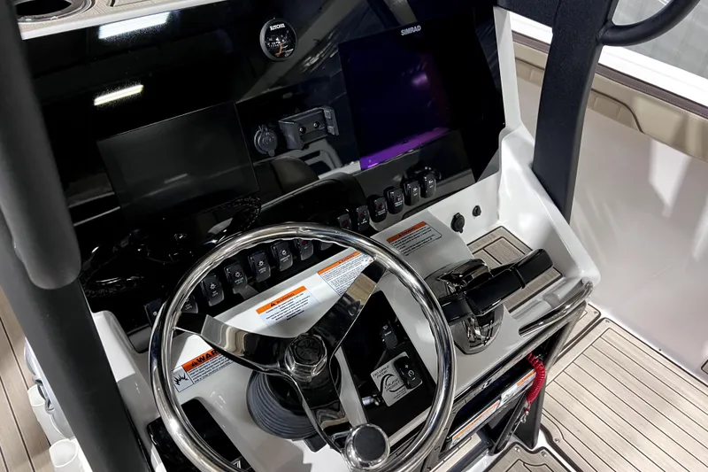 Slide: The Image of 2023 Yamaha Boats 255 FSH Sport E dashboard with steering wheel and controls. - 30