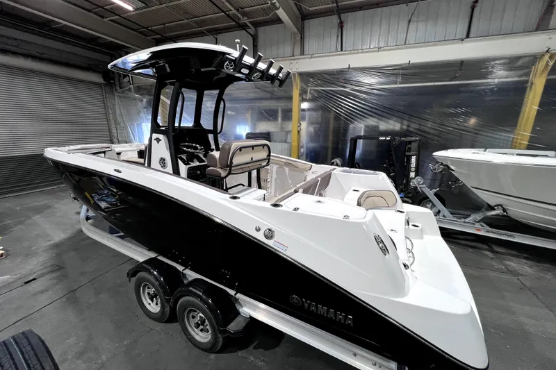 Slide: The Image of 2023 Yamaha Boats 255 FSH Sport E in a showroom, showcasing sleek design and modern features. - 4