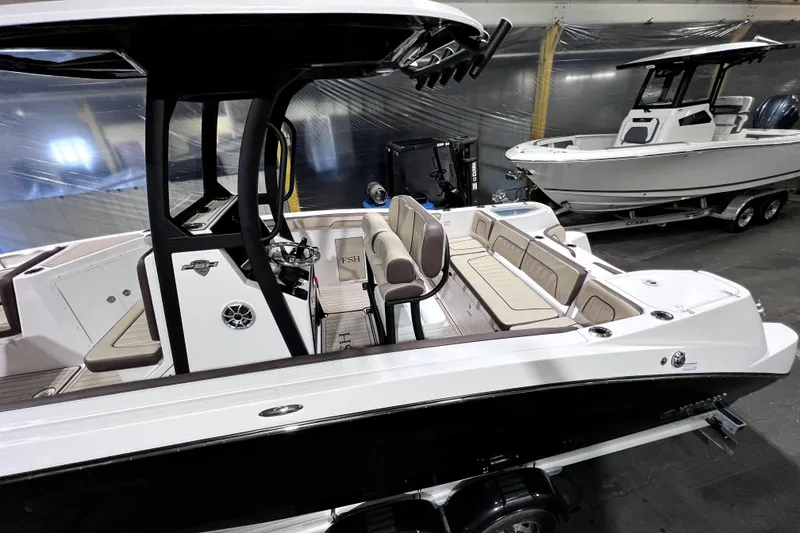 Slide: The Image of 2023 Yamaha Boats 255 FSH Sport E, sleek design, spacious seating, indoor display. - 5