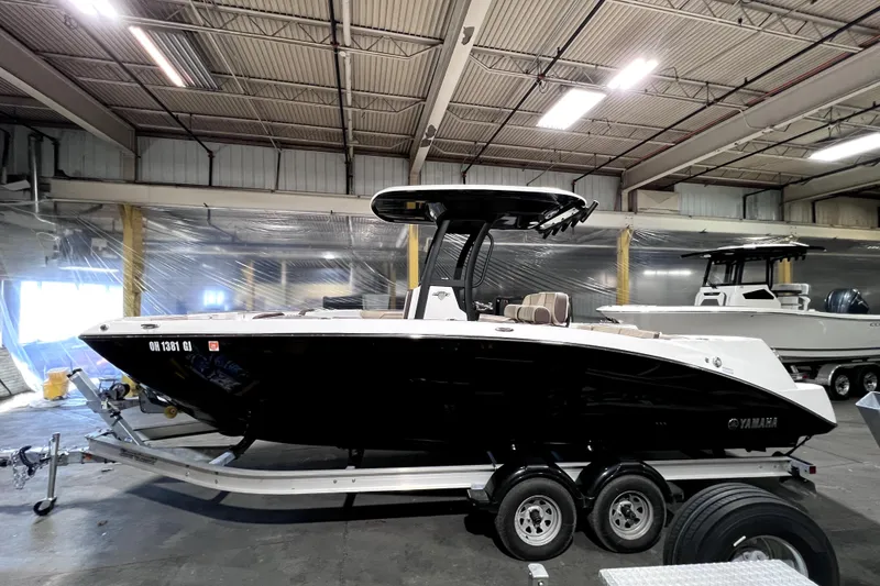 Slide: The Image of 2023 Yamaha Boats 255 FSH Sport E in a warehouse, on a trailer. - 7