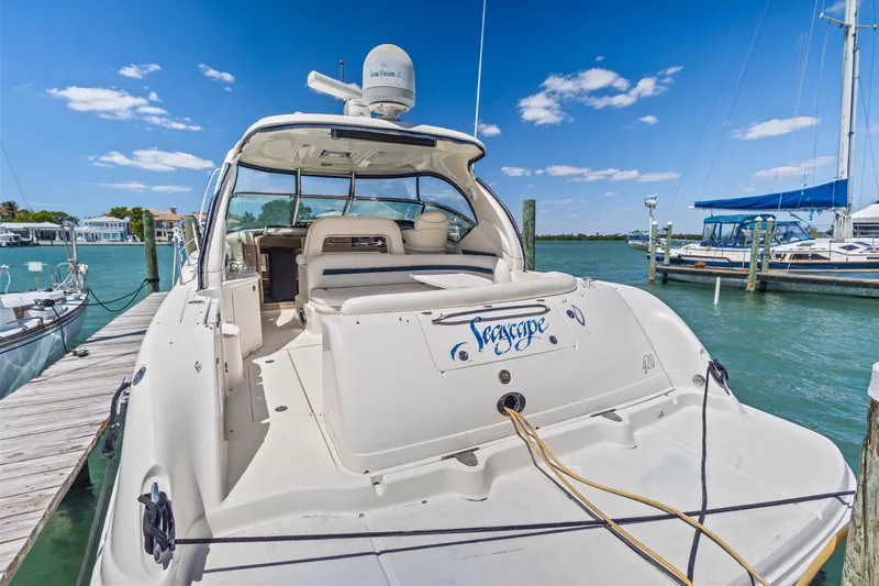 Slide: The Image of 2004 Sea Ray 420 Sundancer yacht docked at marina under clear blue sky. - 11