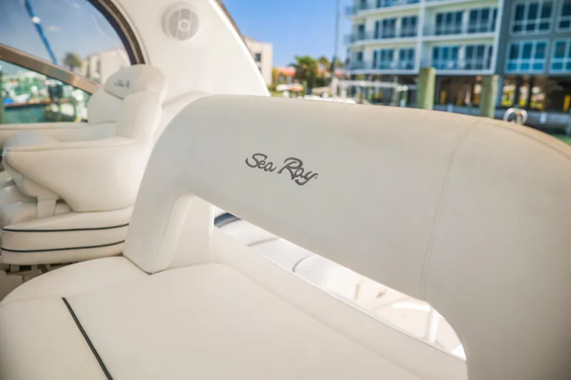 Slide: The Image of 2004 Sea Ray 420 Sundancer interior with white seating and logo detail. - 19