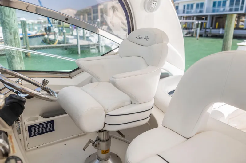 Slide: The Image of Luxurious helm seat on 2004 Sea Ray 420 Sundancer yacht, featuring plush white upholstery. - 21