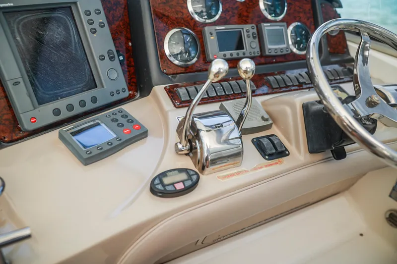 Slide: The Image of Control panel of a 2004 Sea Ray 420 Sundancer boat with steering wheel and navigation instruments. - 22