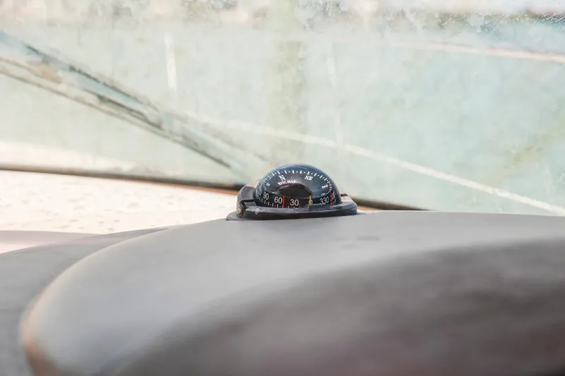 Slide: The Image of Compass on 2004 Sea Ray 420 Sundancer dashboard, with a slightly foggy windshield. - 24