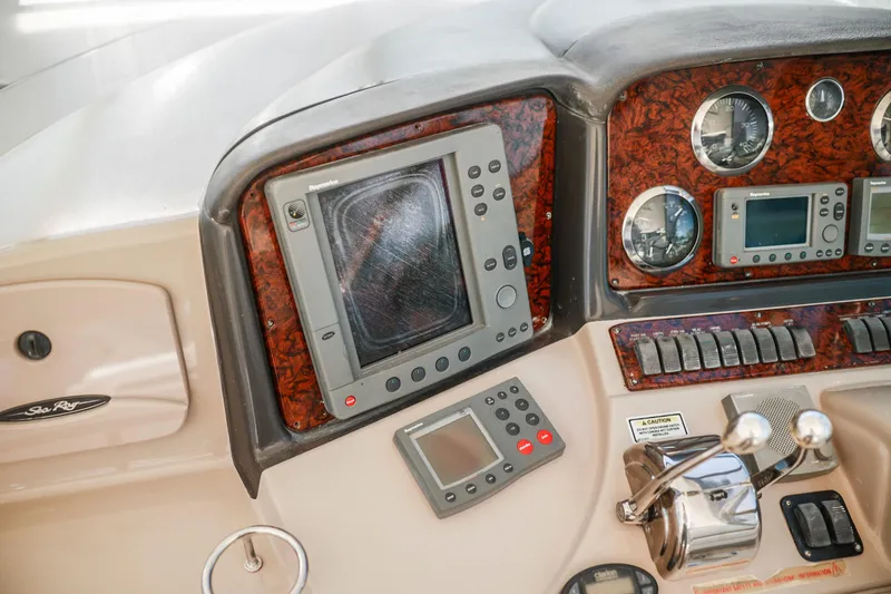 Slide: The Image of Control panel of a 2004 Sea Ray 420 Sundancer boat with navigation instruments. - 25