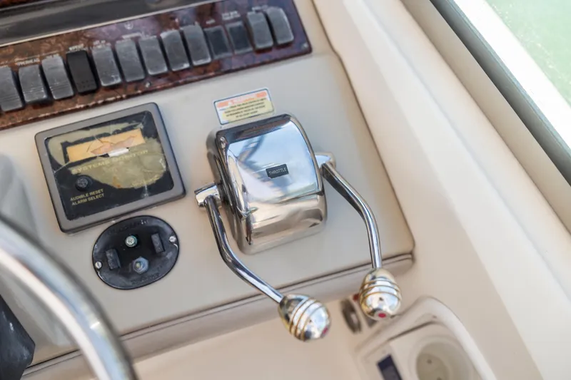 Slide: The Image of Control panel of a 2004 Sea Ray 420 Sundancer boat with throttle levers. - 28