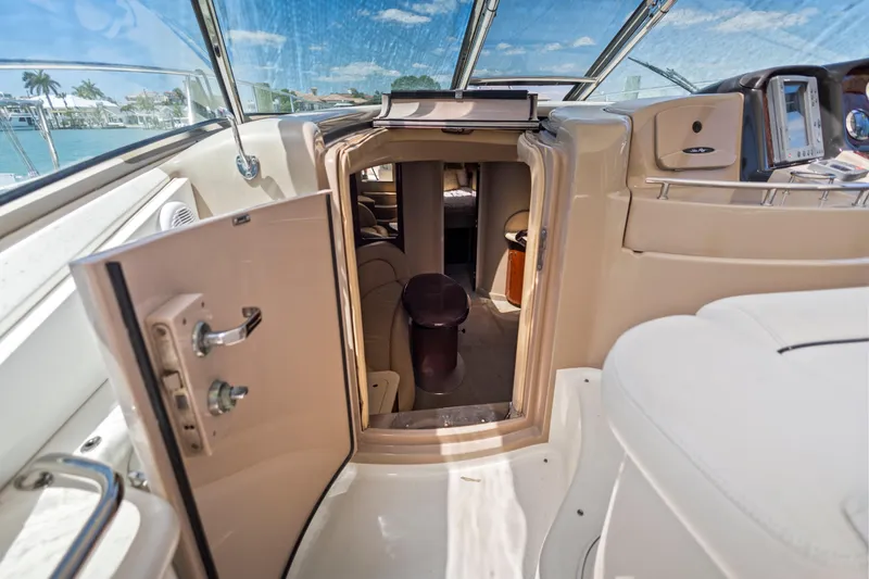 Slide: The Image of 2004 Sea Ray 420 Sundancer cabin entrance with open door, showcasing interior and helm. - 29