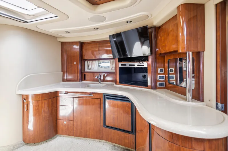 Slide: The Image of Luxurious 2004 Sea Ray 420 Sundancer yacht interior with sleek wood cabinetry and modern amenities. - 31