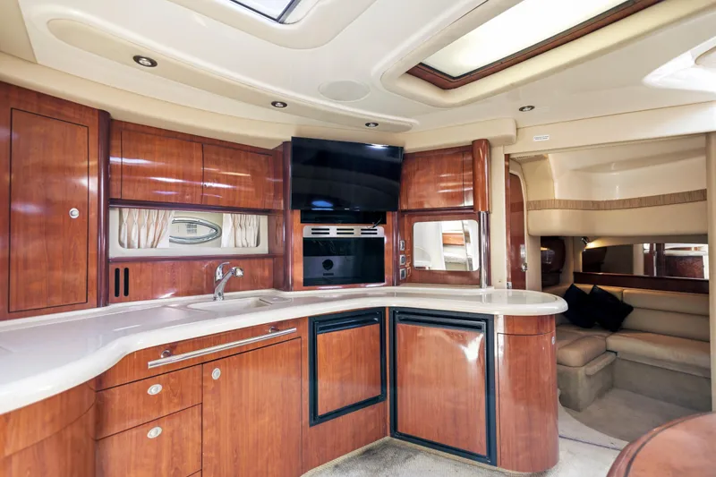 Slide: The Image of Luxurious interior of 2004 Sea Ray 420 Sundancer yacht with modern kitchen amenities. - 33