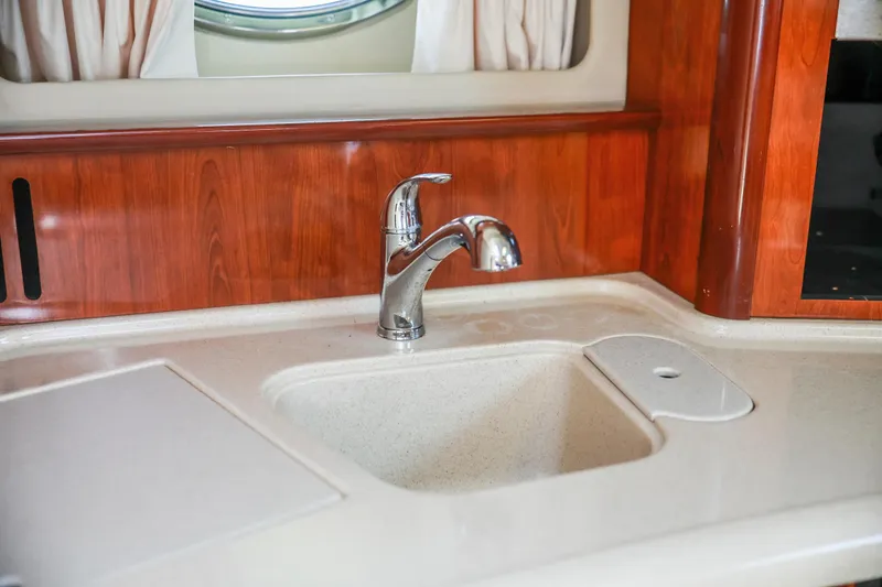 Slide: The Image of Luxury yacht kitchen sink in 2004 Sea Ray 420 Sundancer with wood paneling. - 37