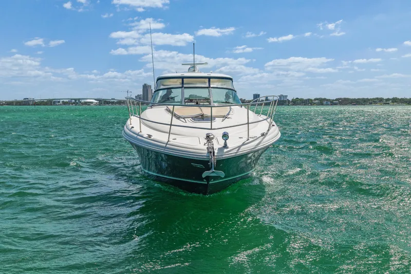 Slide: The Image of 2004 Sea Ray 420 Sundancer yacht cruising on turquoise waters under a clear blue sky. - 4