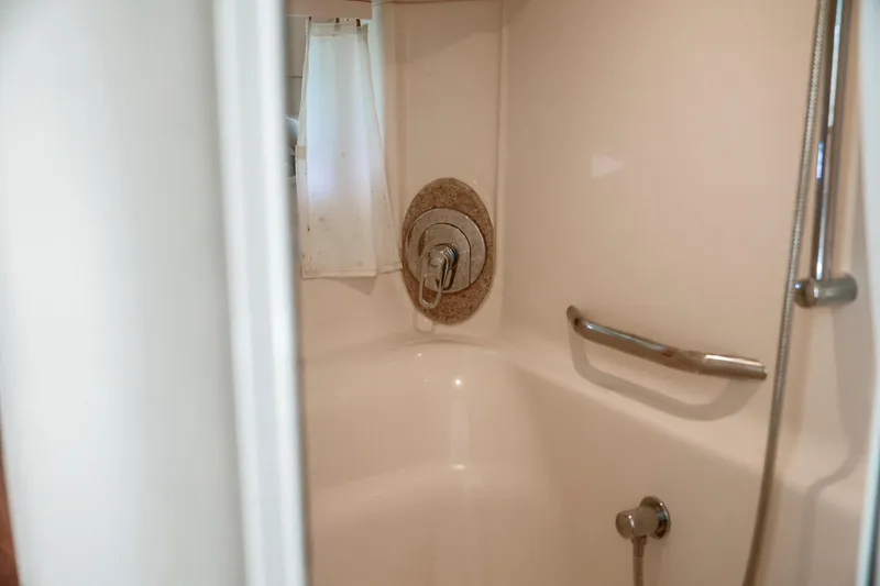 Slide: The Image of Shower area inside 2004 Sea Ray 420 Sundancer yacht, featuring modern fixtures and grab bar. - 43