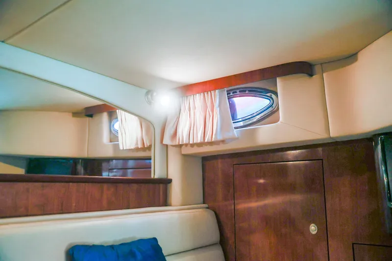 Slide: The Image of Interior cabin of 2004 Sea Ray 420 Sundancer yacht with wood paneling and porthole windows. - 45