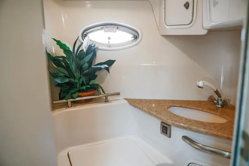 Slide: The Image of Bathroom interior of 2004 Sea Ray 420 Sundancer with plant and oval window. - 46