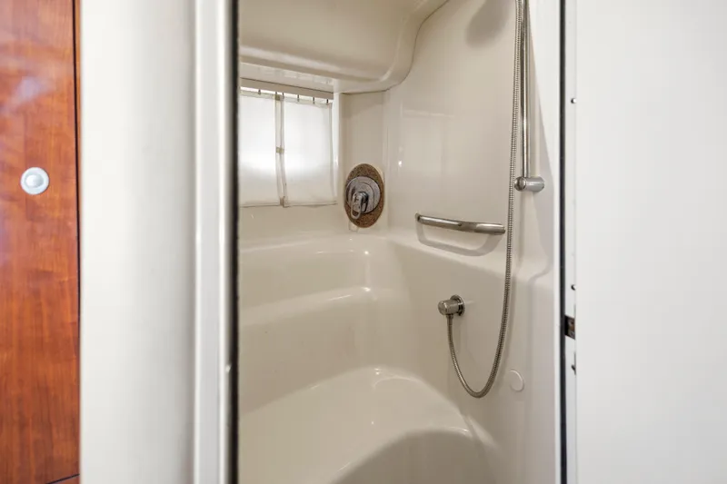 Slide: The Image of Shower area inside 2004 Sea Ray 420 Sundancer yacht, featuring sleek design and fixtures. - 51