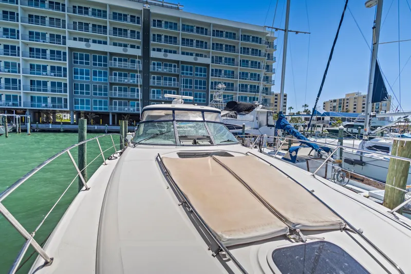 Slide: The Image of 2004 Sea Ray 420 Sundancer yacht docked near waterfront apartments. - 52