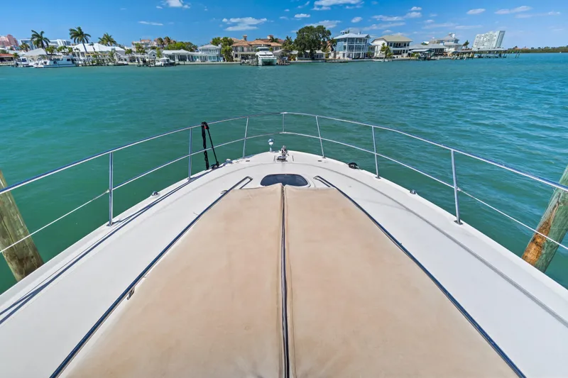 Slide: The Image of 2004 Sea Ray 420 Sundancer yacht cruising in scenic coastal waters. - 54