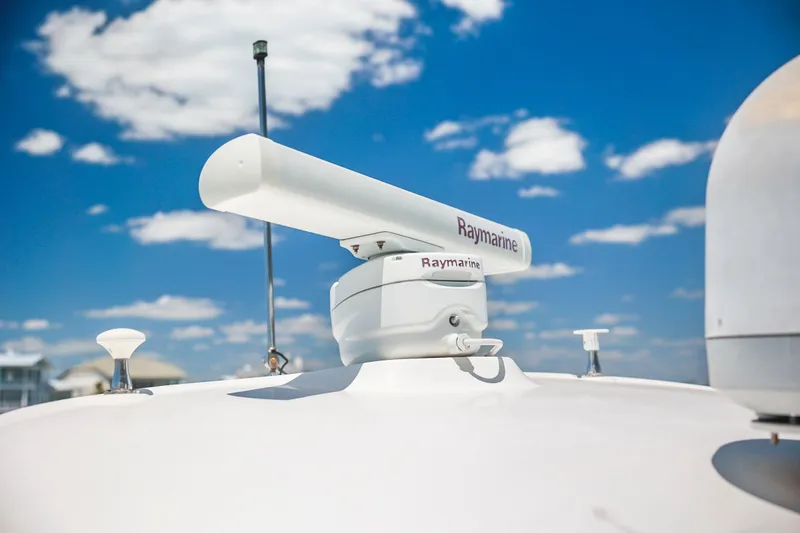 Slide: The Image of Raymarine radar on 2004 Sea Ray 420 Sundancer against a blue sky. - 59