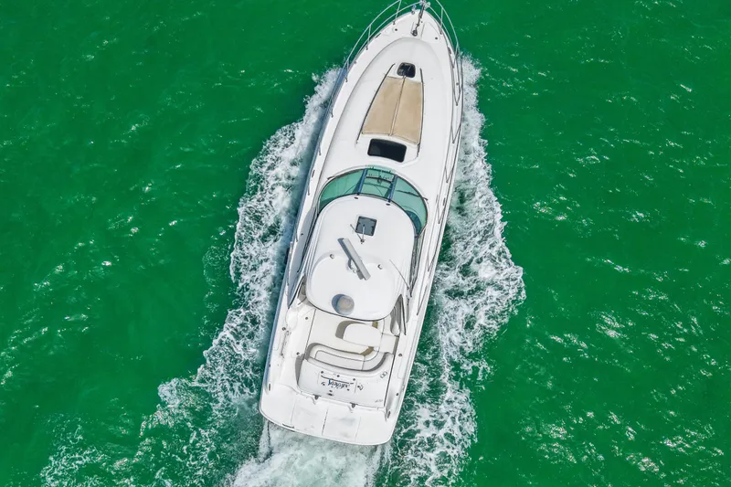 Slide: The Image of Aerial view of 2004 Sea Ray 420 Sundancer yacht cruising on turquoise water. - 8