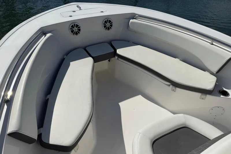Slide: The Image of 2017 Tidewater 220 CC Adventure boat interior with cushioned seating and speakers. - 10