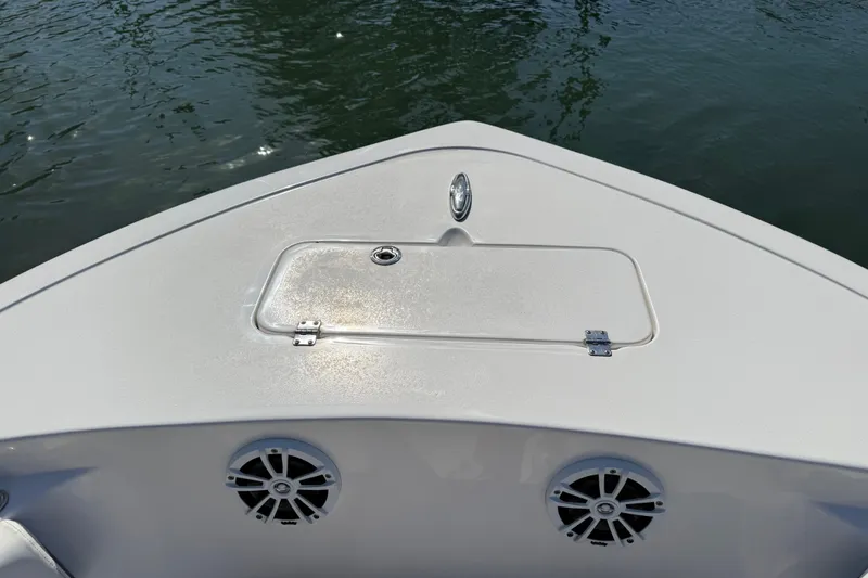 Slide: The Image of Bow of 2017 Tidewater 220 CC Adventure boat with storage hatch and speakers. - 13