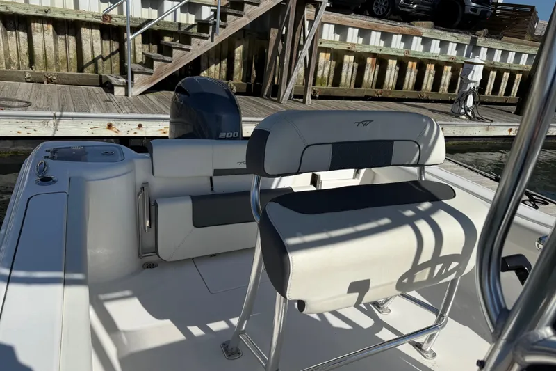 Slide: The Image of 2017 Tidewater 220 CC Adventure boat interior with seating and outboard motor. - 19