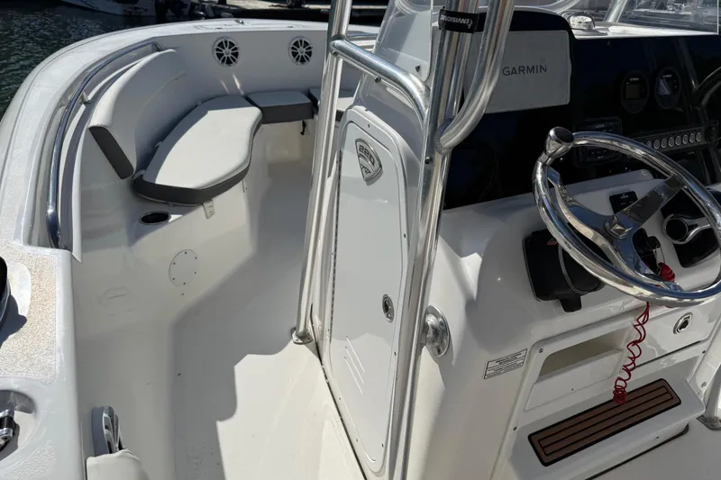 Slide: The Image of 2017 Tidewater 220 CC Adventure boat interior with steering wheel and seating area. - 23