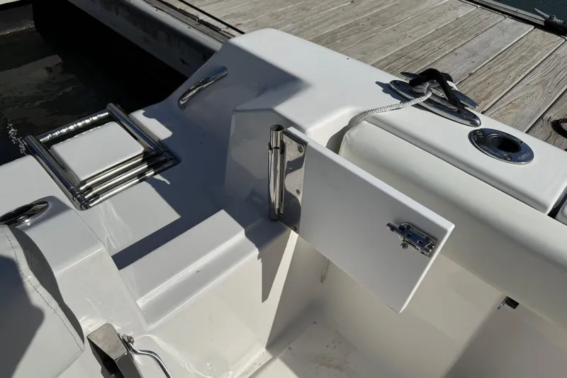Slide: The Image of 2017 Tidewater 220 CC Adventure boat with open hatch and docked ladder. - 29