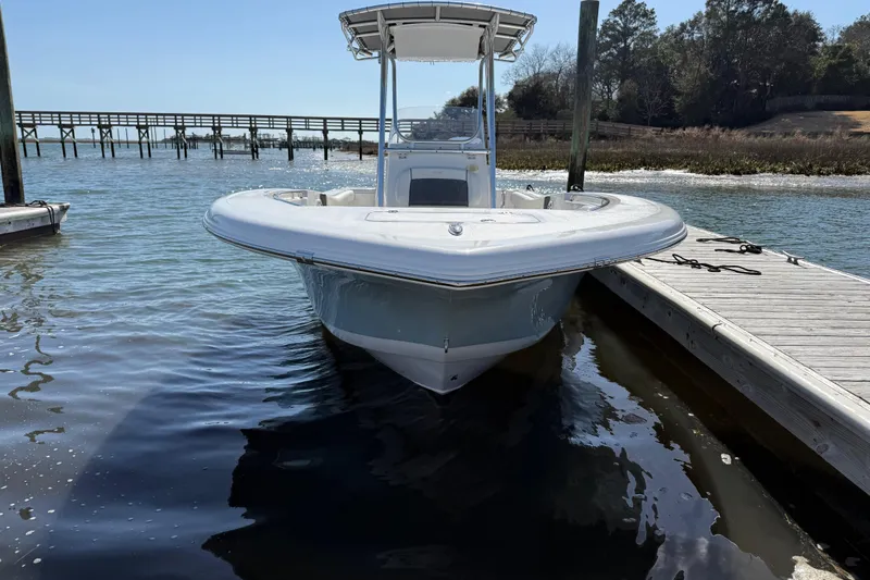Slide: The Image of 2017 Tidewater 220 CC Adventure boat docked on calm water. - 3