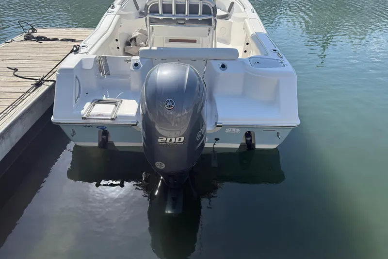 Slide: The Image of 2017 Tidewater 220 CC Adventure boat with Yamaha 200 engine docked on calm water. - 8