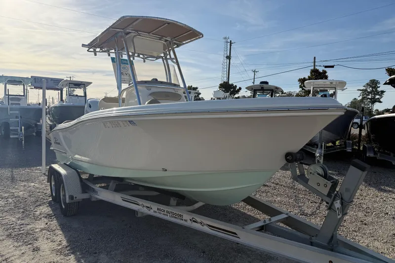 Slide: The Image of 2021 Pioneer 202 Islander boat on trailer, displayed outdoors in a dealership lot. - 16