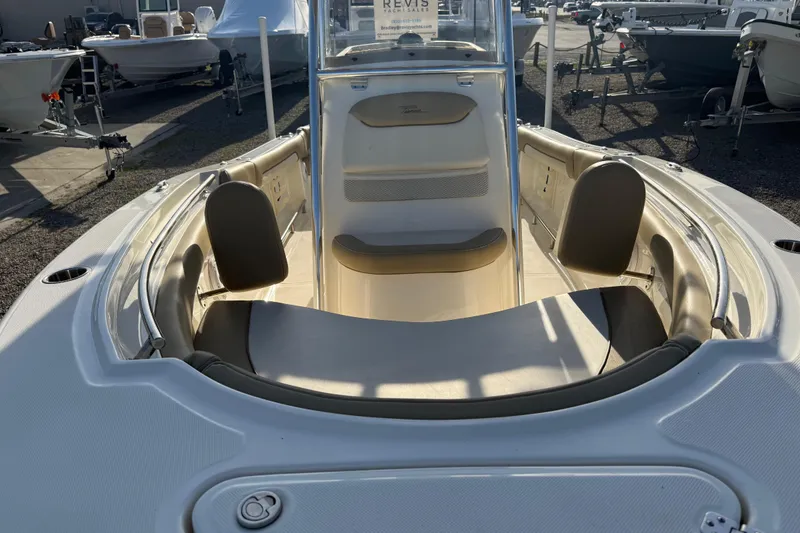 Slide: The Image of 2021 Pioneer 202 Islander boat interior with seating and console, displayed outdoors. - 18