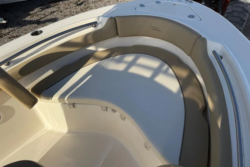 Slide: The Image of 2021 Pioneer 202 Islander boat interior with cushioned seating and stainless steel railings. - 19