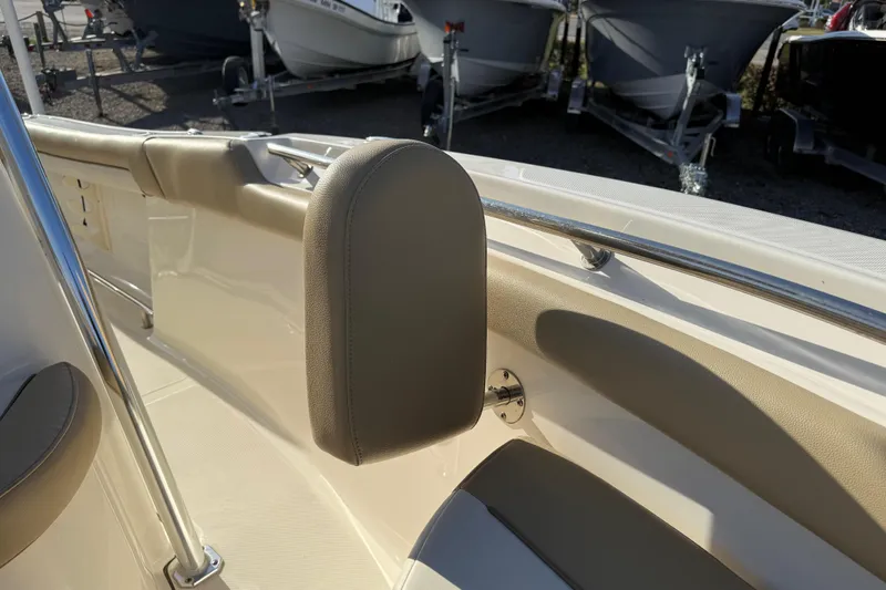 Slide: The Image of 2021 Pioneer 202 Islander boat interior with beige seating and stainless steel railing. - 20