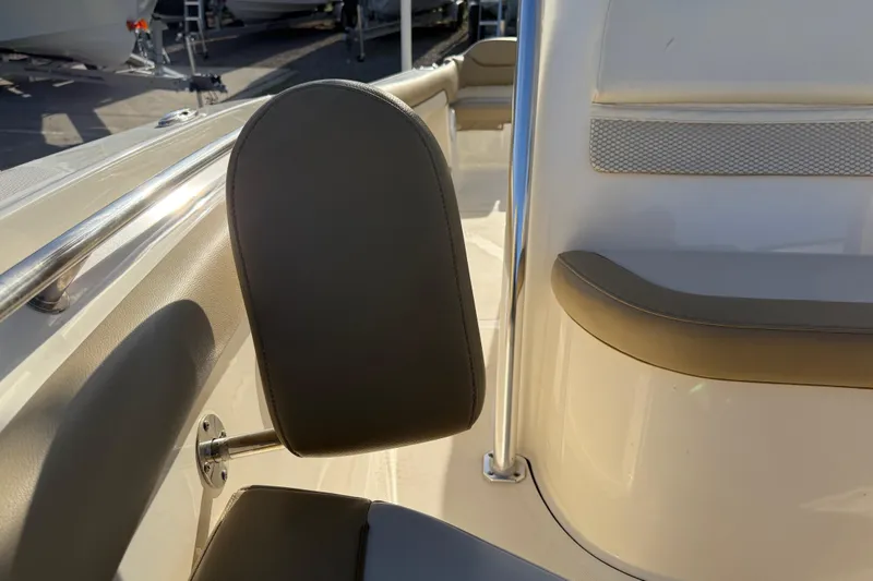 Slide: The Image of 2021 Pioneer 202 Islander boat interior with cushioned seating and stainless steel railing. - 21