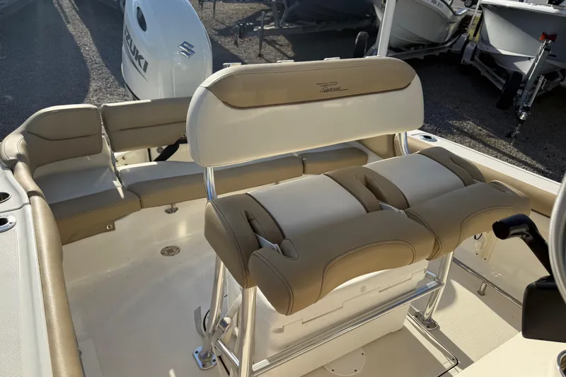 Slide: The Image of 2021 Pioneer 202 Islander boat interior with beige seating and Suzuki engine. - 27