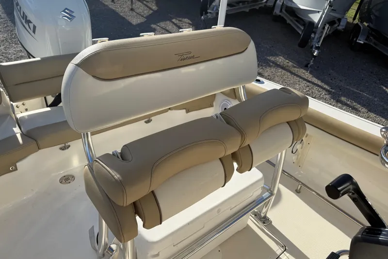 Slide: The Image of 2021 Pioneer 202 Islander boat interior with beige seating and Suzuki engine. - 29