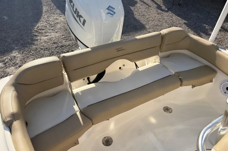 Slide: The Image of 2021 Pioneer 202 Islander boat interior with beige seating and Suzuki engine. - 30