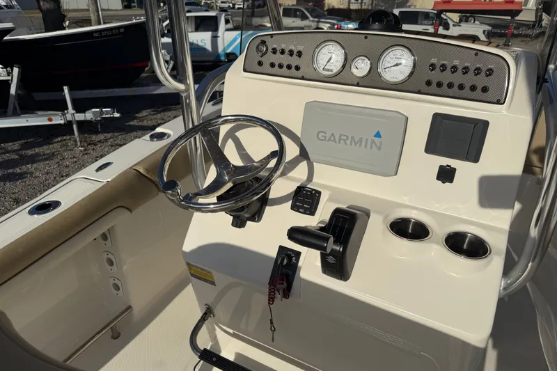 Slide: The Image of 2021 Pioneer 202 Islander boat dashboard with Garmin navigation system and steering wheel. - 34