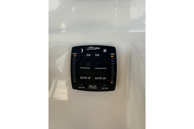 Slide: The Image of Control panel of a 2021 Pioneer 202 Islander boat, featuring trim tab controls. - 36