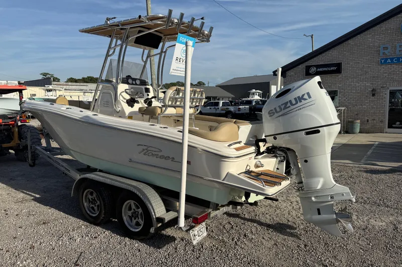 Slide: The Image of 2021 Pioneer 202 Islander boat with Suzuki outboard motor on trailer, parked outside dealership. - 5
