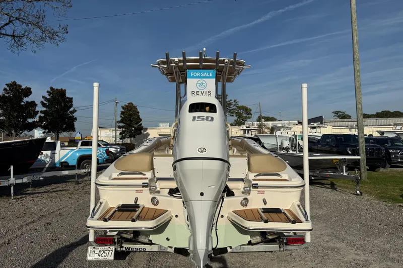 Slide: The Image of 2021 Pioneer 202 Islander boat for sale, rear view with motor, parked outdoors. - 8