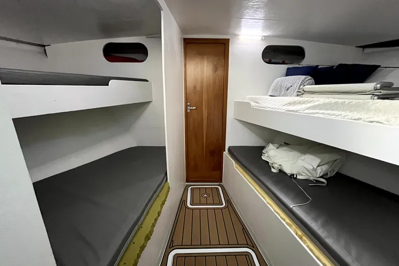 Slide: The Image of Interior of 1982 Torres Boat Mfg 43, featuring bunk beds and wooden flooring. - 10