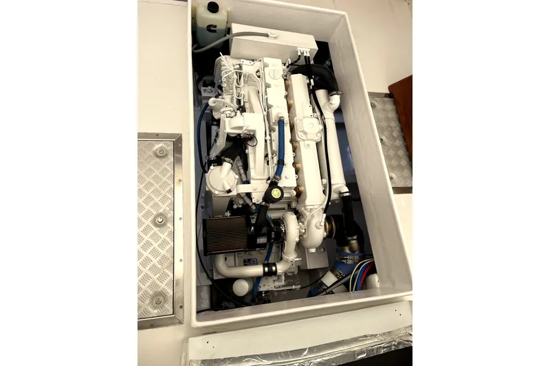 Slide: The Image of Engine compartment of a 1982 Torres Boat Mfg 43, showcasing a clean, well-maintained marine engine. - 16