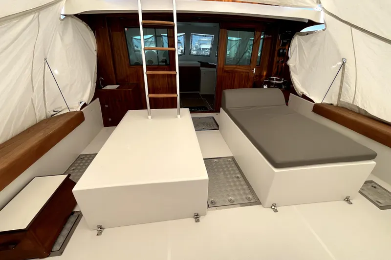 Slide: The Image of Interior of a 1982 Torres Boat Mfg 43, featuring seating and ladder under a canopy. - 21