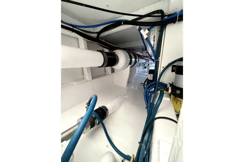 Slide: The Image of Engine room of a 1982 Torres Boat Mfg 43, showcasing pipes and wiring. - 26