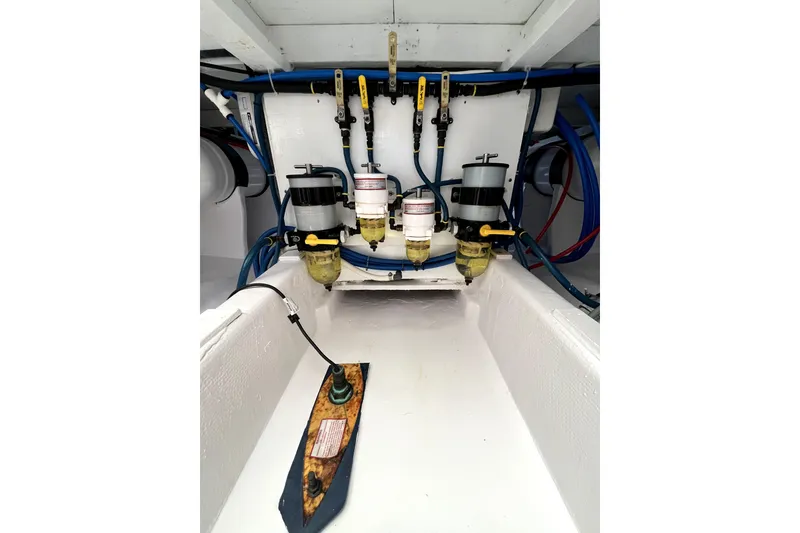 Slide: The Image of Engine compartment of a 1982 Torres Boat Mfg 43, showcasing fuel filters and plumbing. - 27